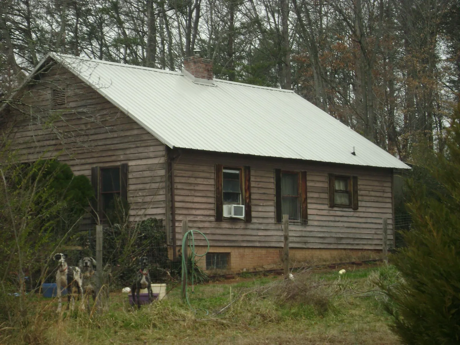 White metal roof on an old wood sided farmhouse, from a Metal Roof Installation job in Bogart